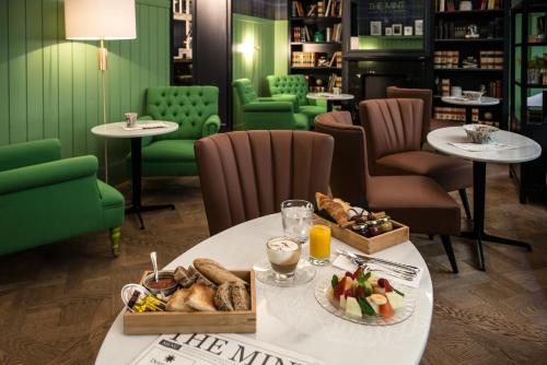 a table with a plate of food on it at Vincci The Mint in Madrid