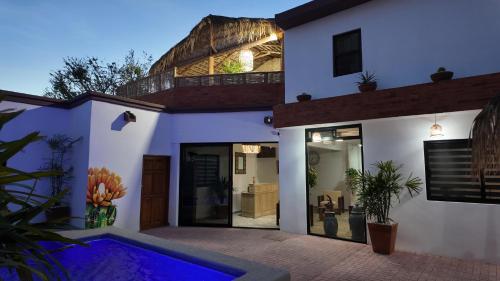 a house with a swimming pool in front of it at MarJor Suites in La Paz