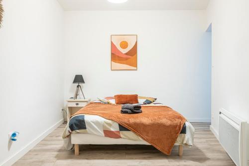 a bedroom with a bed with a teddy bear on it at La Perle de Pau in Pau