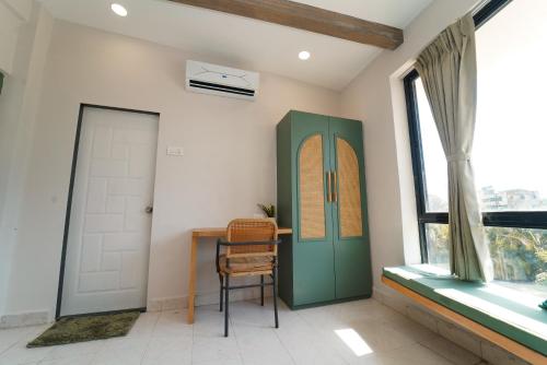 a room with a door and a chair and a window at Voyage Zo Lonavala in Lonavala