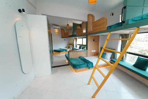 a room with a bunk bed and a living room at Voyage Zo Lonavala in Lonavala