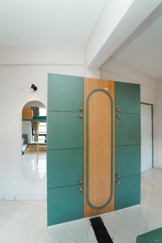 a green cabinet with a wooden door in a room at Voyage Zo Lonavala in Lonavala