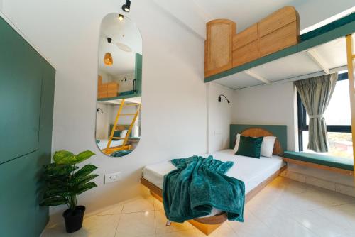 a bedroom with a bunk bed and a mirror at Voyage Zo Lonavala in Lonavala