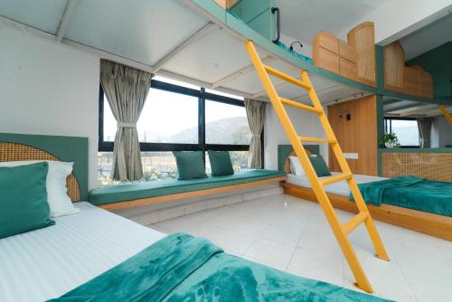 a bedroom with a bunk bed and a ladder at Voyage Zo Lonavala in Lonavala