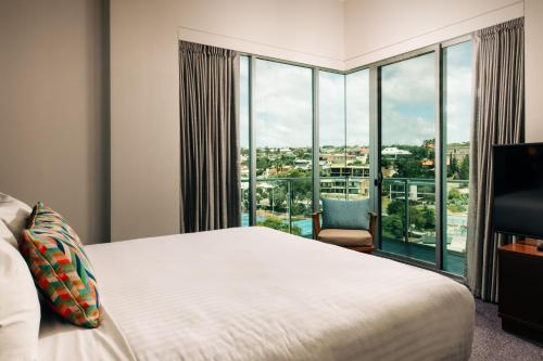 a bedroom with a bed and a large window at Port Lincoln Hotel in Port Lincoln
