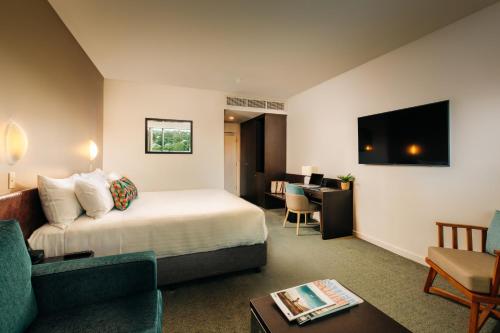 a hotel room with a bed and a living room at Port Lincoln Hotel in Port Lincoln