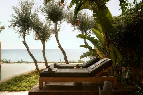 a couch sitting on a table next to the beach at F ZEEN Kefalonia in Lourdhata