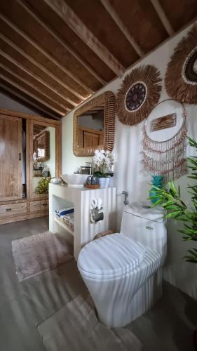 a bathroom with a toilet and a sink at Kubu Dimel Suites and Villas Resort in Nusa Dua