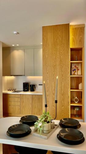 a kitchen with a table with four black plates on it at The First by 22 in Piraeus