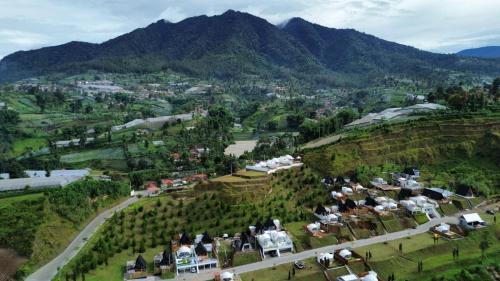 an aerial view of a village on a mountain at glamping dome Wrg in Tegalharendong