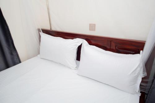 two white pillows on a bed in a room at Novella Guesthouse in Arua