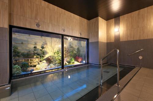 a swimming pool with a large aquarium in a building at Hotel Route Inn Ginan -Kokudo 21 Gou- in Ginan