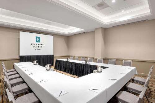 a conference room with a large white table and chairs at Embassy Suites by Hilton Anaheim South in Anaheim