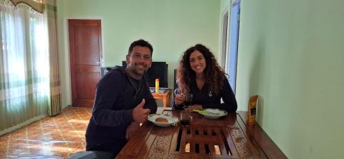 a man and a woman sitting at a table at Wisma PO'ONG in Ruteng