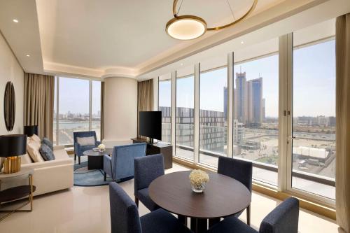 a living room with a view of a city at Hilton Bahrain City Centre Hotel & Residences in Manama