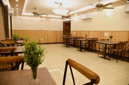 a banquet hall with tables and chairs in a room at Hotel Atlantis Continental in New Delhi