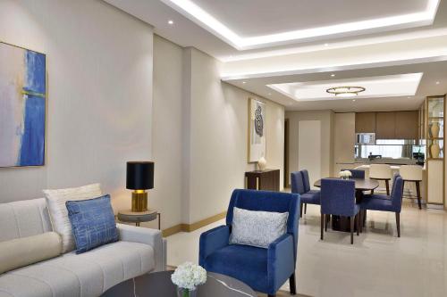 a living room with a couch and chairs and a table at Hilton Bahrain City Centre Hotel & Residences in Manama