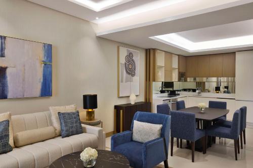 a living room with a couch and chairs and a table at Hilton Bahrain City Centre Hotel & Residences in Manama