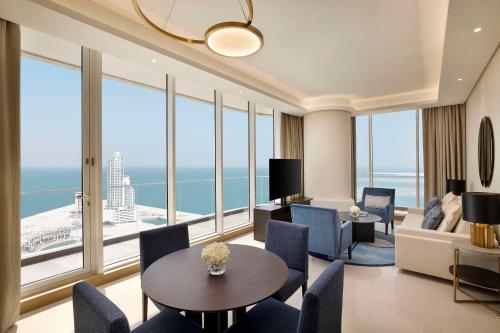 a living room with a view of the ocean at Hilton Bahrain City Centre Hotel & Residences in Manama