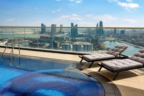 a swimming pool on the roof of a building at Hilton Bahrain City Centre Hotel & Residences in Manama