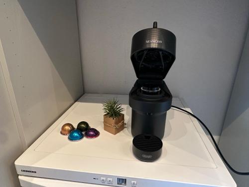 a black coffee maker sitting on top of a tv at Bergträumerei in Bad Goisern