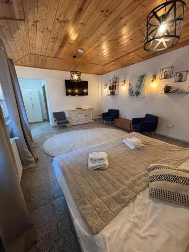 a bedroom with a large bed with two towels on it at Drachenhaus Urban Villa in Braşov