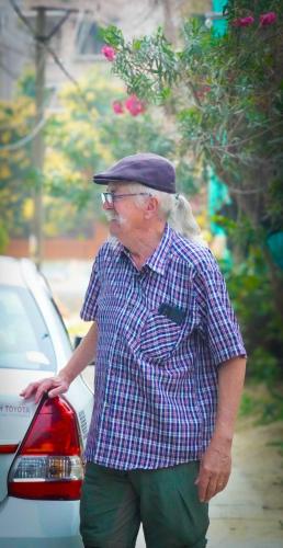 an older man is standing next to a car at Risabya Guest House in Gājol