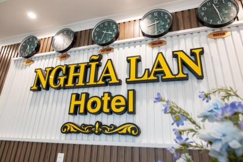 a sign for a hotel with clocks on the wall at Nghia Lan Hotel in Da Lat