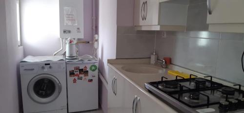 a kitchen with a stove and a washing machine at Samlife Apart in Samsun