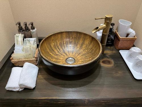 a bowl sink on a counter in a bathroom at Oyado Koto No Yume in Takayama