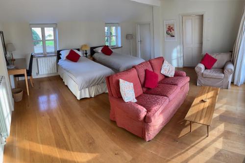 a living room with a couch and two beds at Field Cottage Bed and Continental Breakfast in East Harling