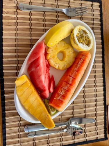 a plate of fruit and vegetables on a table at Madiha Venus in Matara