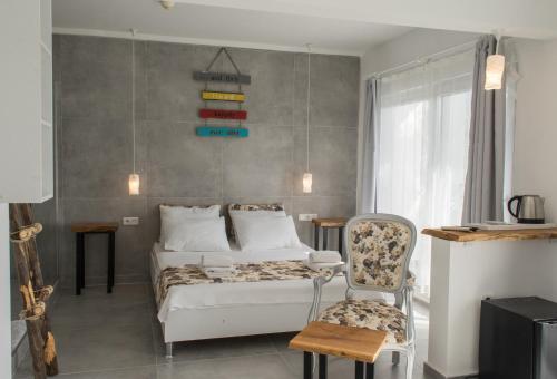 a bedroom with a bed and a chair at Pataros Hotel in Patara