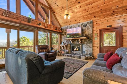 a living room with two couches and a fireplace at Smoky Overlook in Sevierville