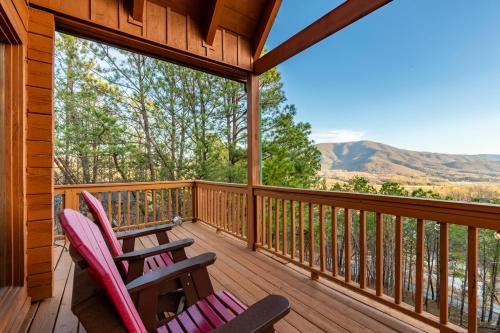 two chairs on a deck with a view of the mountains at Smoky Overlook in Sevierville