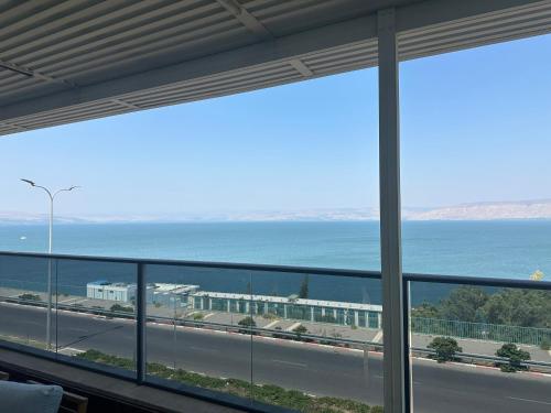 a view of the ocean from a building at לוי-קיישן מגוון דירות גן ופנטהאוזים וסוויטות נוף ברחוב הצנחנים in Tiberias