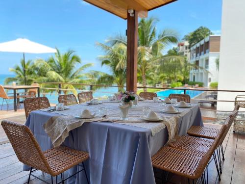 a table on a deck with a view of the ocean at X-Sea Khanom Harbor Bay Resort in Khanom