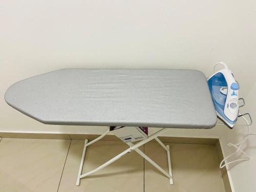a white desk with a blue ironing board at SKS Larkin Stadium Larkin Terminal Bus Town Area JB City in Johor Bahru