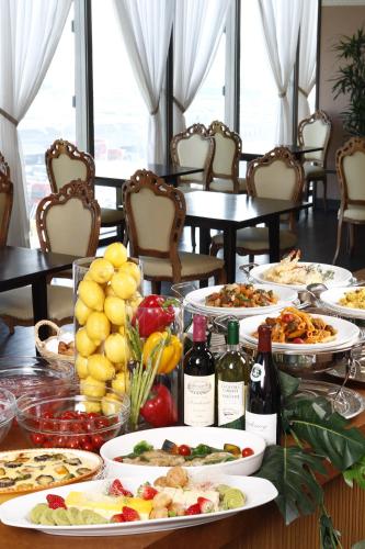 a table with plates of food and bottles of wine at 衣浦グランドホテル in Takahama