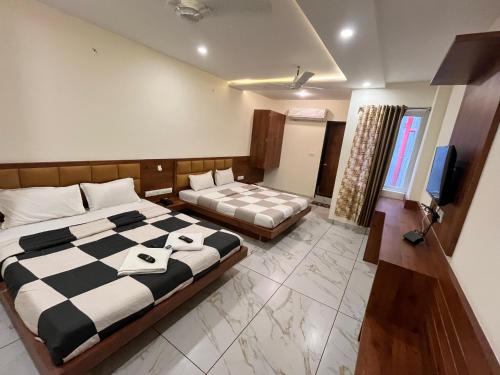 Postel nebo postele na pokoji v ubytování Hotel PRAKASHAM