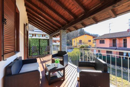 a patio with two chairs and a table on a balcony at Casa Allegra in Orta San Giulio