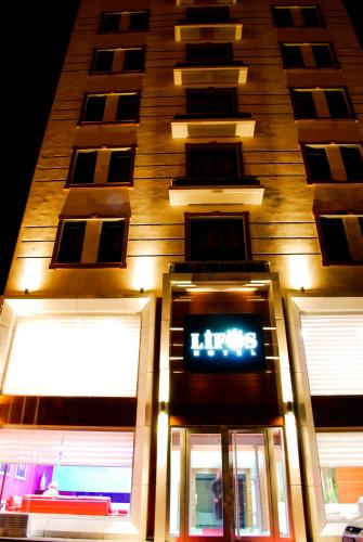 a tall building with a clock on the front of it at Lifos Hotel in Kayseri