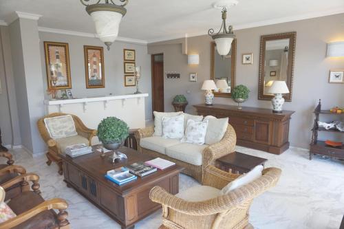 a living room with a couch and a table at Faros Suites (Adults Only) in Fiskardho