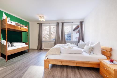 a bedroom with two beds and a bunk bed at Linde Apartment in Reutte