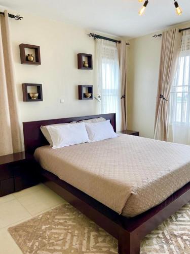 a bedroom with a large bed in a room at 3 Bed Luxury Condo in Lubowa in Kampala