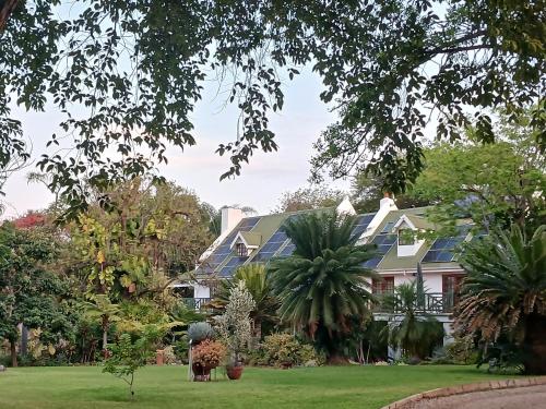 a house with solar panels on its roof at Cuckoos Nest Guest House in Louis Trichardt