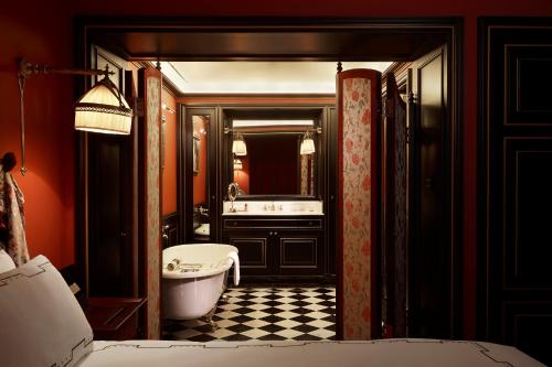 a bathroom with a tub and a sink and a toilet at L'Escape Hotel in Seoul