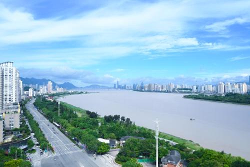 a view of a city with a river and buildings at Pullman Wenzhou in Wenzhou