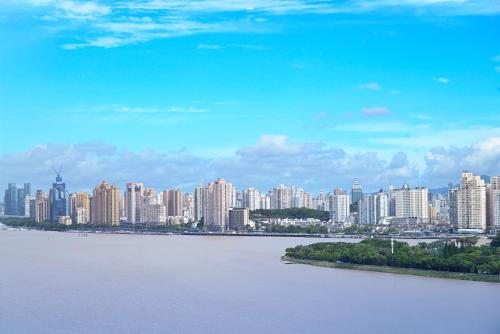 a view of a city with a river and buildings at Pullman Wenzhou in Wenzhou
