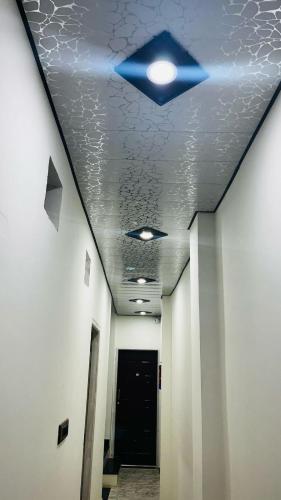 a hallway with a ceiling with a blue light on it at Neelkanth pg house in Varanasi